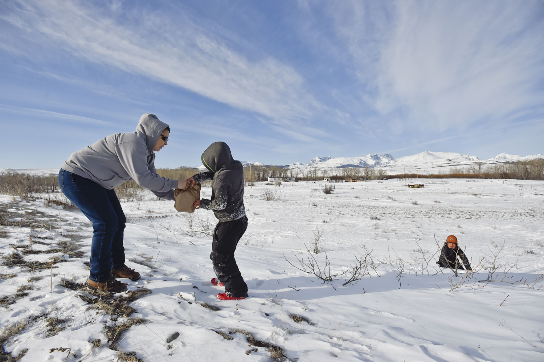 Nicklo Crossguns delivers sack breakfasts to two young boys